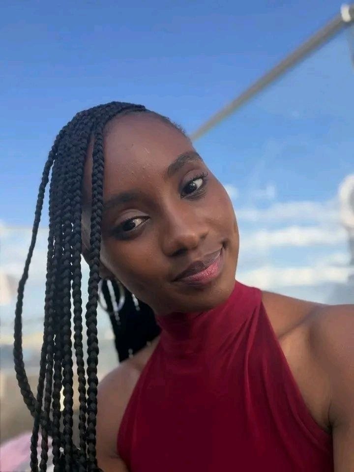 a woman with long braids in a red dress
